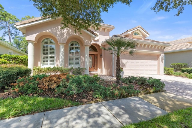 mediterranean / spanish-style home with a garage