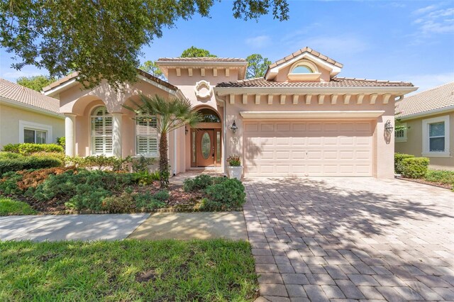 mediterranean / spanish-style house with a garage