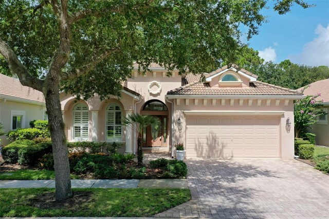 mediterranean / spanish house featuring a garage