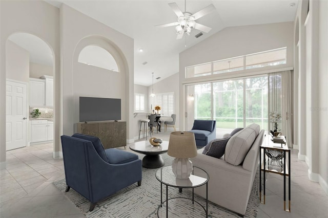 tiled living room with high vaulted ceiling and ceiling fan