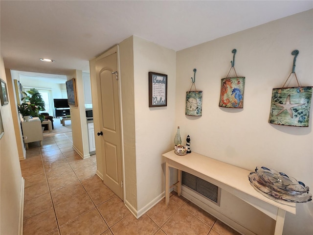 hall featuring light tile patterned flooring