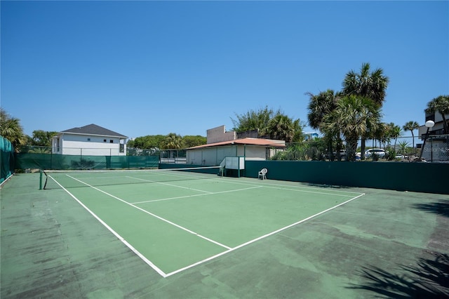 view of tennis court featuring fence