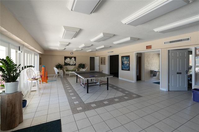 game room featuring baseboards, visible vents, and light tile patterned flooring