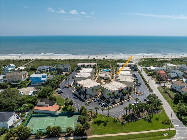 birds eye view of property with a water view and a beach view