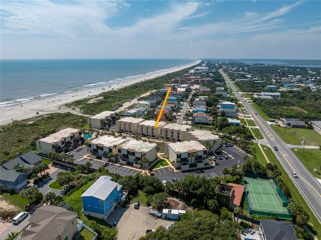 birds eye view of property with a water view and a beach view