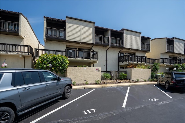 view of property featuring uncovered parking