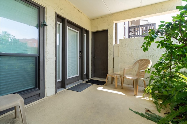 entrance to property with stucco siding