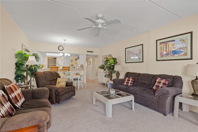 living area featuring light carpet, visible vents, a textured ceiling, and ceiling fan with notable chandelier