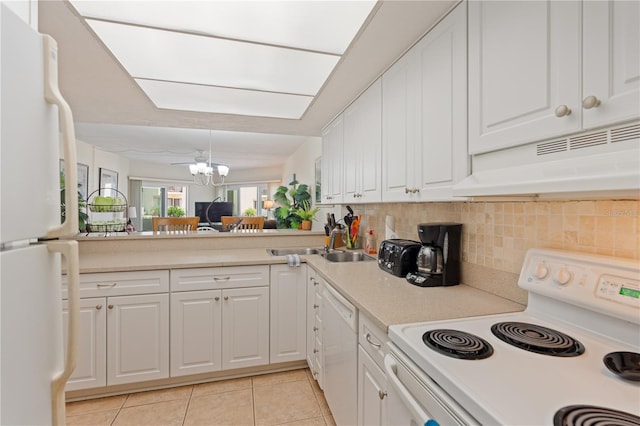 kitchen with sink, light tile patterned flooring, a notable chandelier, white appliances, and white cabinets