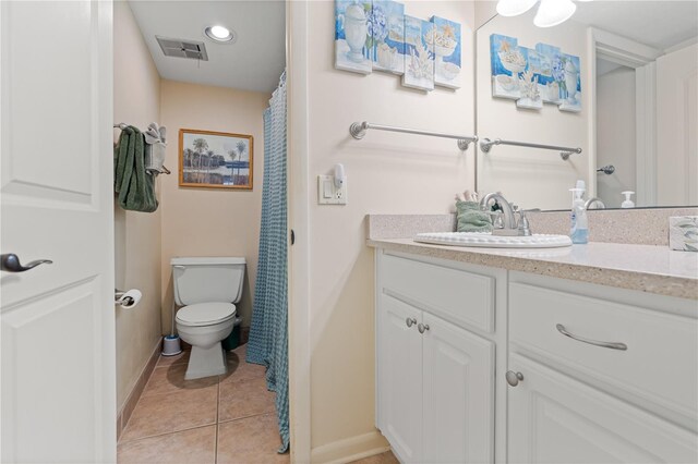 bathroom with tile patterned flooring, vanity, and toilet