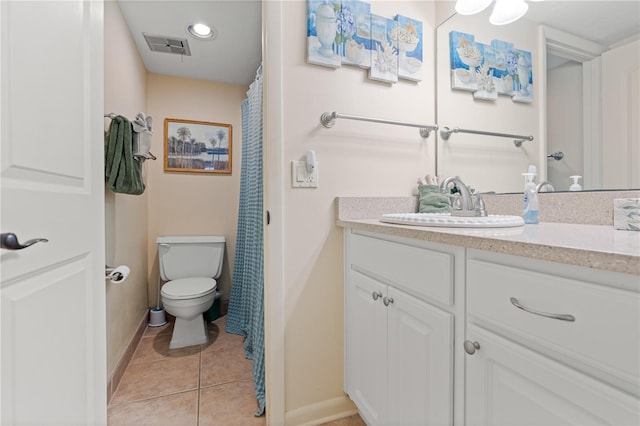 bathroom featuring visible vents, toilet, vanity, baseboards, and tile patterned floors