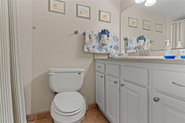 bathroom with tile patterned floors, vanity, and toilet