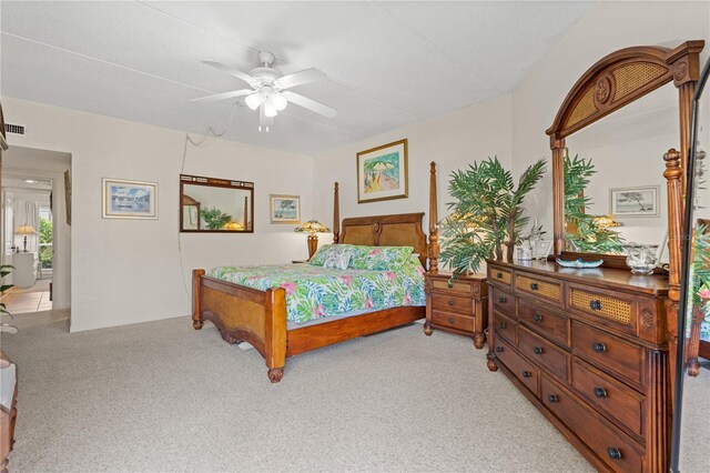 bedroom featuring light carpet and ceiling fan