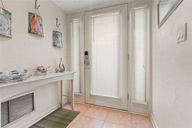 doorway with plenty of natural light and light tile patterned floors