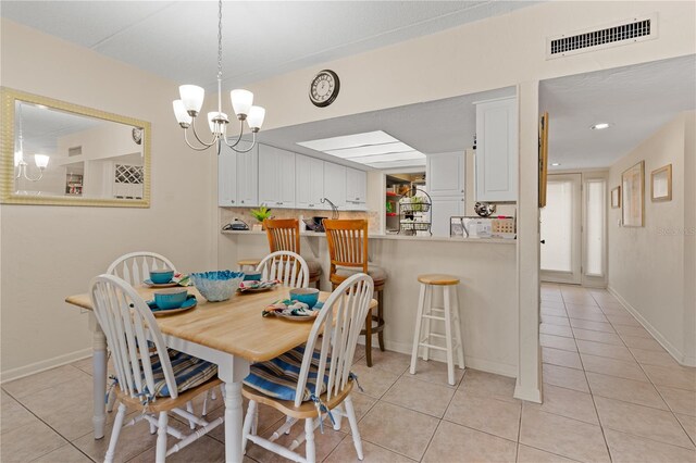 tiled dining space featuring a notable chandelier