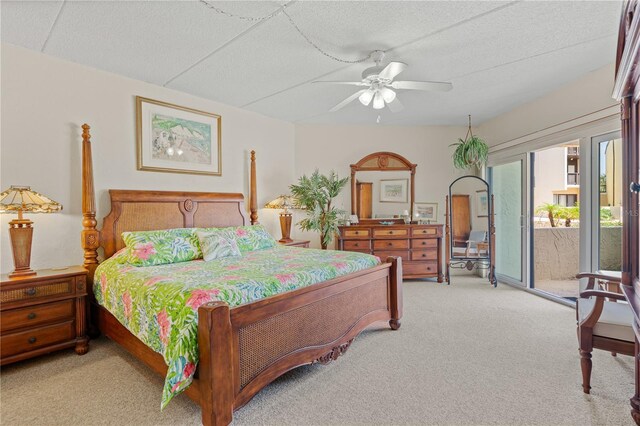 bedroom featuring light carpet, access to outside, and ceiling fan