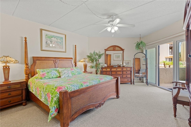 bedroom featuring access to exterior, light carpet, a textured ceiling, and a ceiling fan