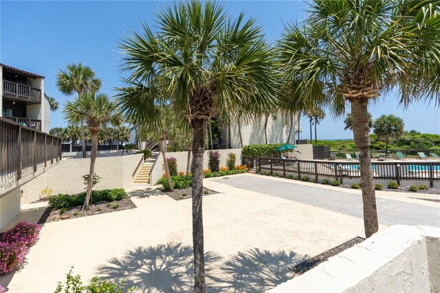 view of property's community featuring a pool and a patio area