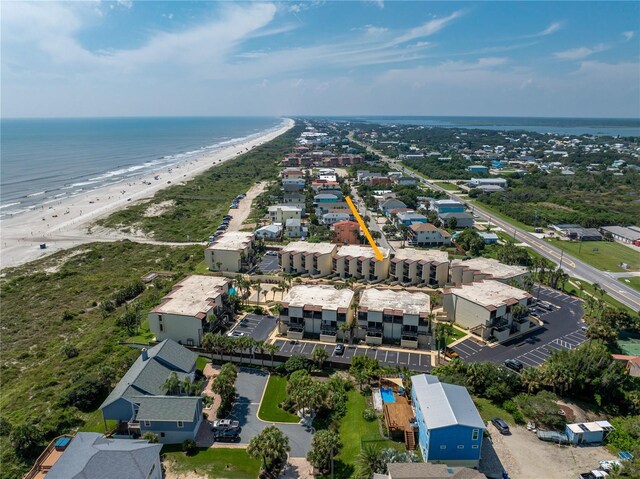 drone / aerial view featuring a water view and a beach view