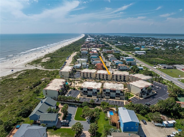 birds eye view of property with a beach view, a residential view, and a water view