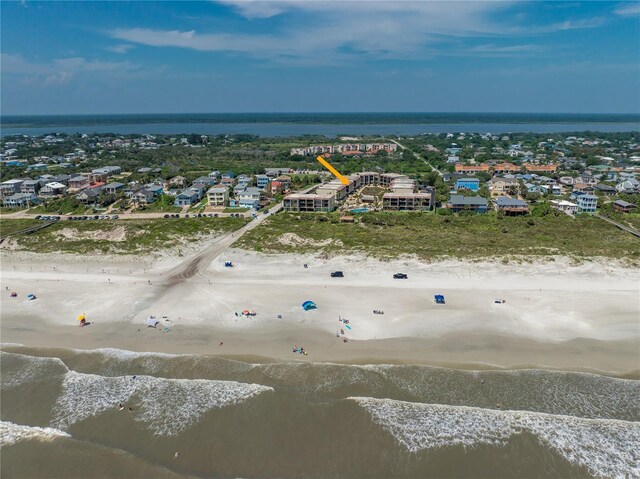 birds eye view of property with a water view and a view of the beach