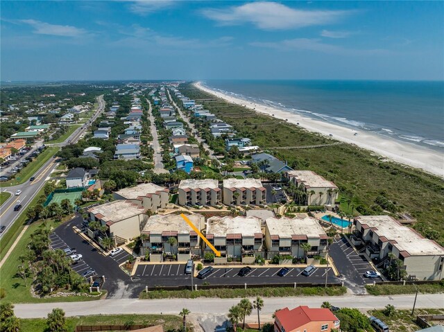 birds eye view of property with a water view and a view of the beach