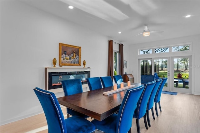 dining area featuring light hardwood / wood-style flooring, ceiling fan, and french doors