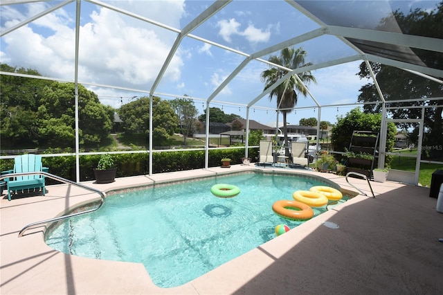 view of pool featuring a patio and glass enclosure