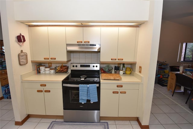 kitchen featuring light tile patterned flooring, decorative backsplash, electric stove, and white cabinets