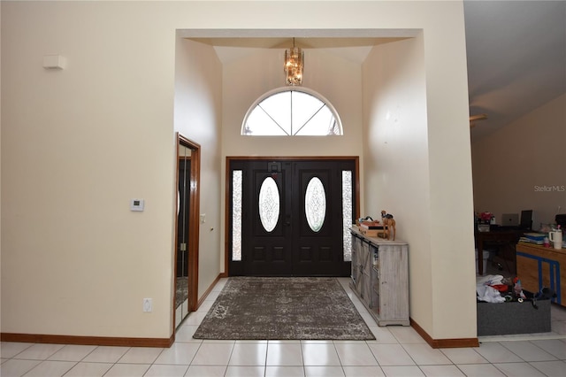 tiled foyer entrance featuring lofted ceiling