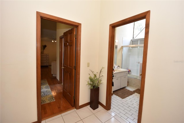 hall with light tile patterned floors