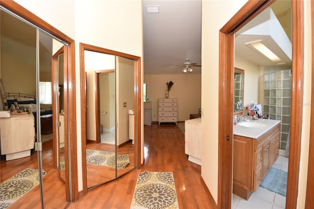 hall featuring sink and hardwood / wood-style floors