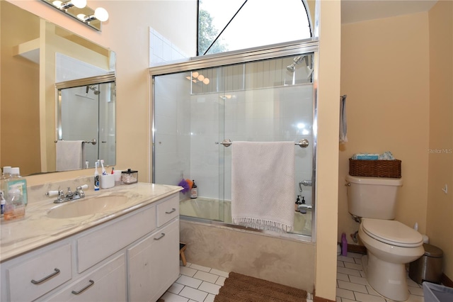 full bathroom with tile patterned floors, shower / bath combination with glass door, toilet, and vanity