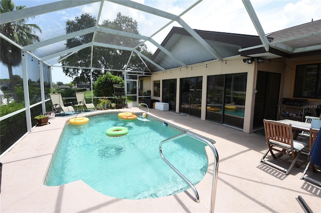 view of swimming pool with a patio and glass enclosure