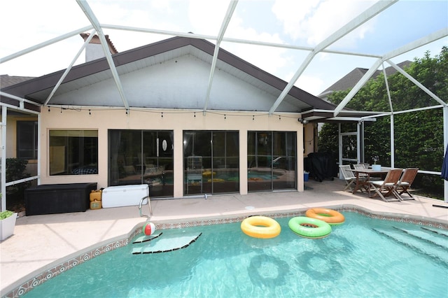 view of swimming pool with a patio and a lanai