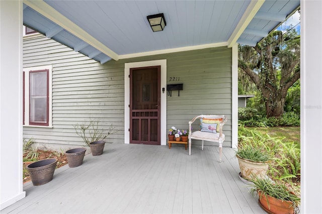 view of exterior entry featuring a porch