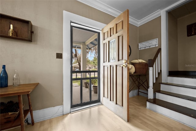 entrance foyer with light hardwood / wood-style flooring and ornamental molding