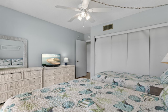 bedroom with a ceiling fan, visible vents, and a closet