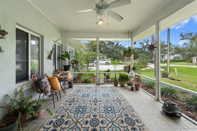 sunroom / solarium with a ceiling fan