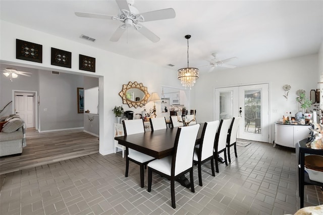 dining room with french doors, visible vents, baseboards, and ceiling fan with notable chandelier