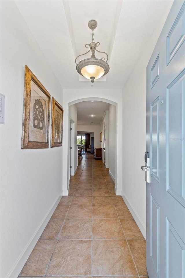 hall featuring light tile patterned floors