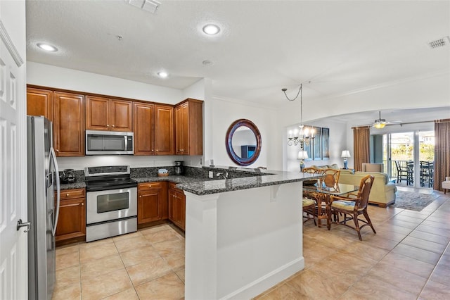 kitchen with pendant lighting, light tile patterned floors, stainless steel appliances, kitchen peninsula, and dark stone counters