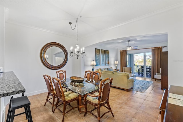 tiled dining room with ceiling fan with notable chandelier and ornamental molding