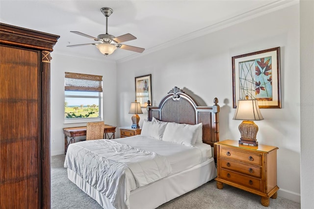 carpeted bedroom with ceiling fan and crown molding