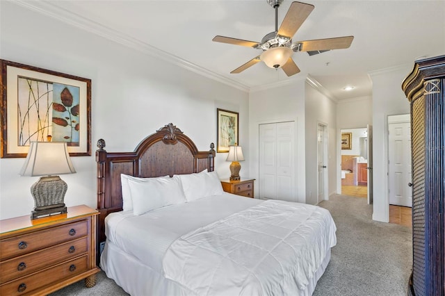 carpeted bedroom featuring a closet, ornamental molding, and ceiling fan