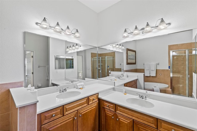 bathroom featuring vanity and shower with separate bathtub