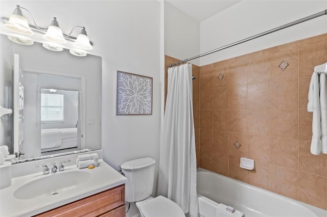 full bathroom with toilet, shower / tub combo with curtain, and vanity