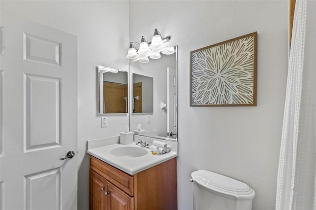 bathroom with toilet and vanity