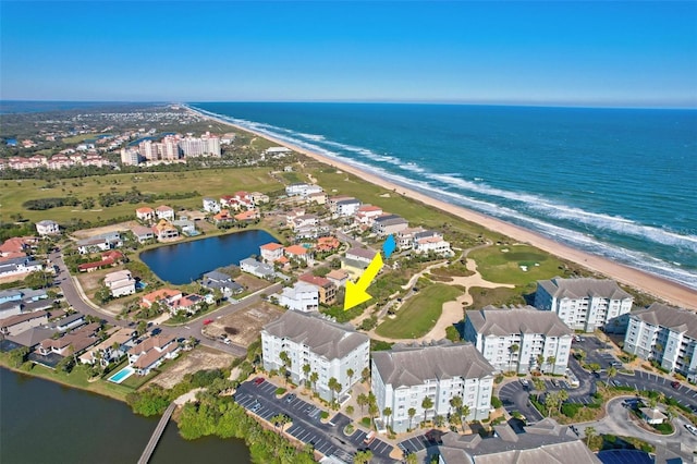 birds eye view of property featuring a water view and a view of the beach