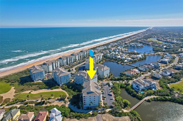 bird's eye view featuring a water view and a beach view